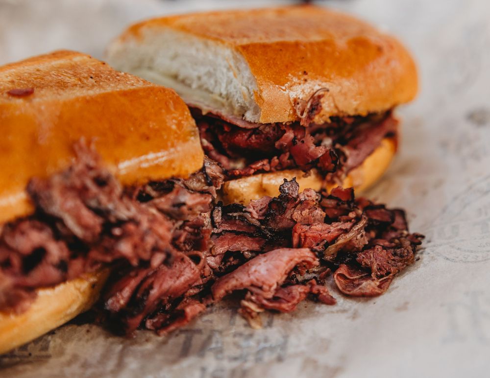 Pastrami sandwich close-up with pastrami spilling out of the bun