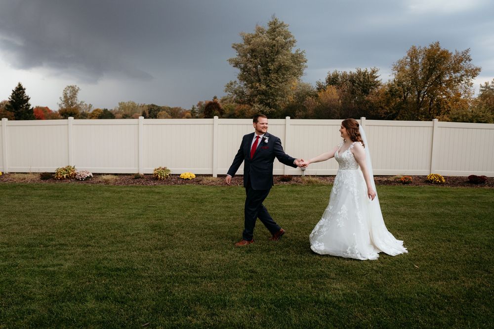 Wedding Bride and Groom walking along a grassy path during an outdoor ceremony. Detroit Golf Course Michigan.