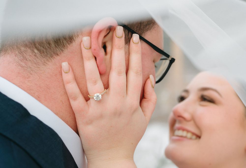 A romantic series of close-up shots showing couples embracing and smiling during intimate wedding moments.