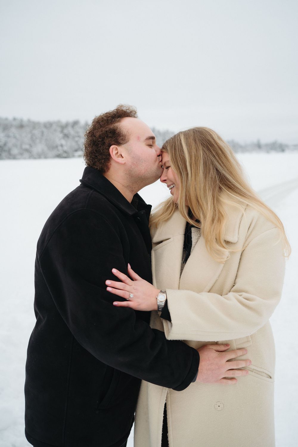 A romantic moment between a couple during a winter proposal.