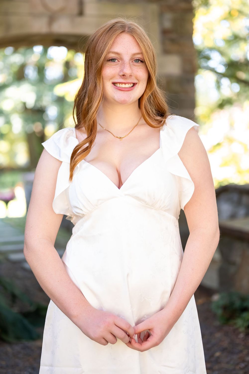 A series of four portrait photos showing someone in a white ruffled dress smiling outdoors in natural lighting.