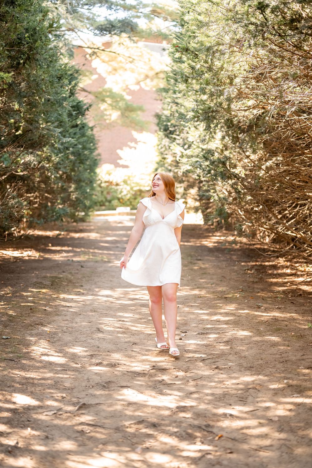 A sequence of photos showing a person in a white dress walking through a sunlit garden path with evergreen shrubs.