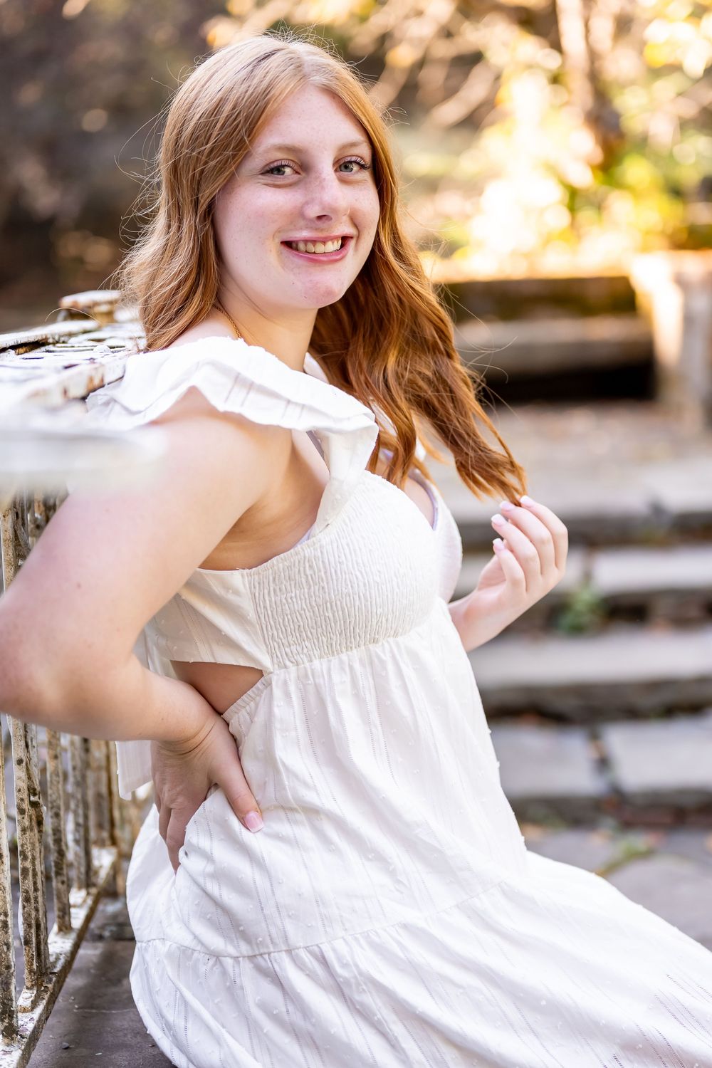 A person in a white summer dress poses outdoors in a series of connected photos showing movement and playful expressions.