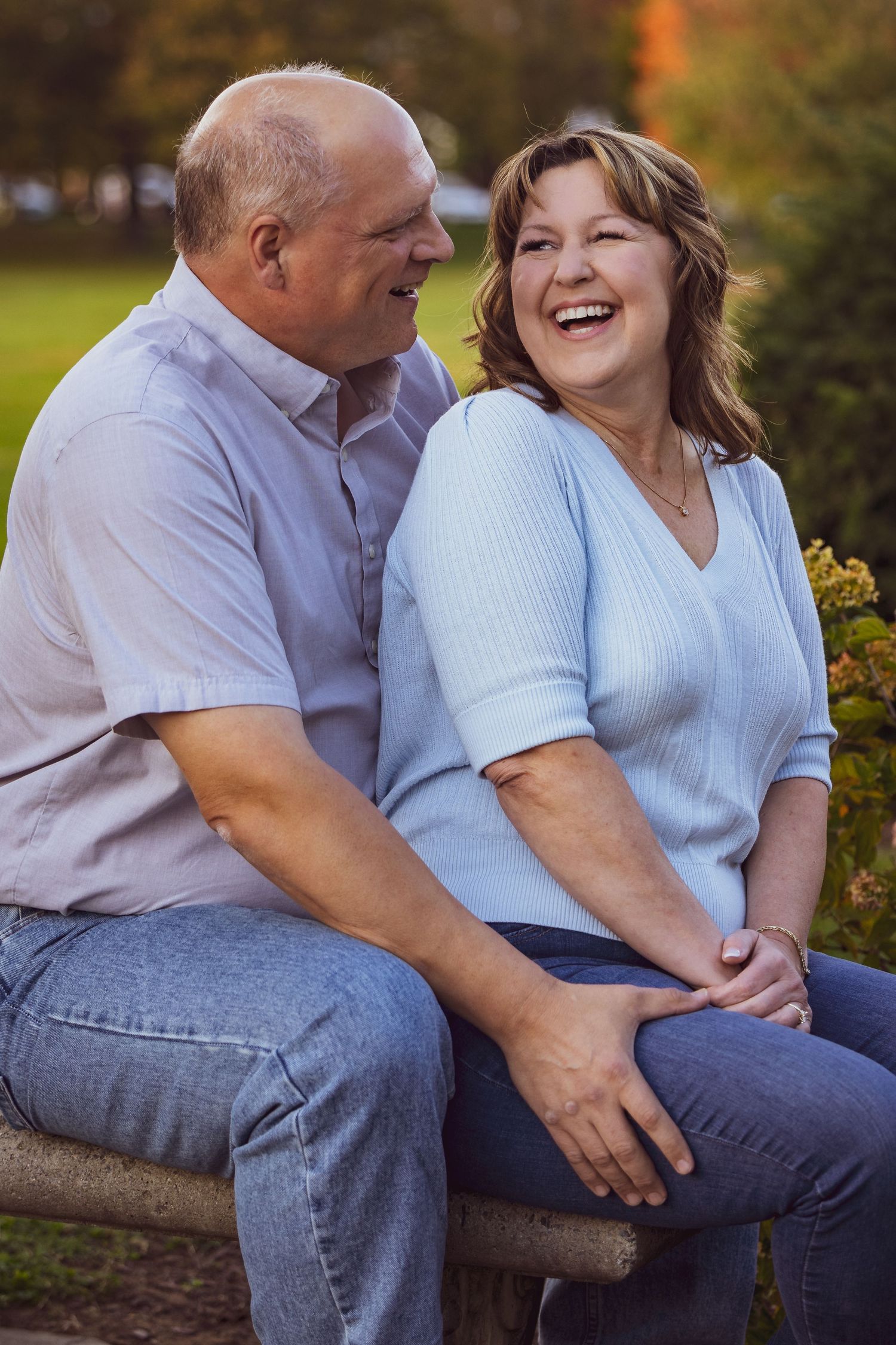 Frederick Maryland Wedding Photographer   A couple in light blue and white sits close together outdoors sharing intimate moments.