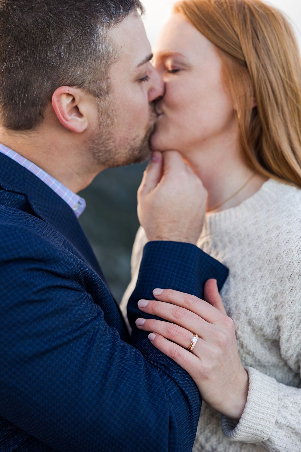 A romantic close-up sequence shows a couple sharing intimate kisses while wearing winter attire against a blurred background.