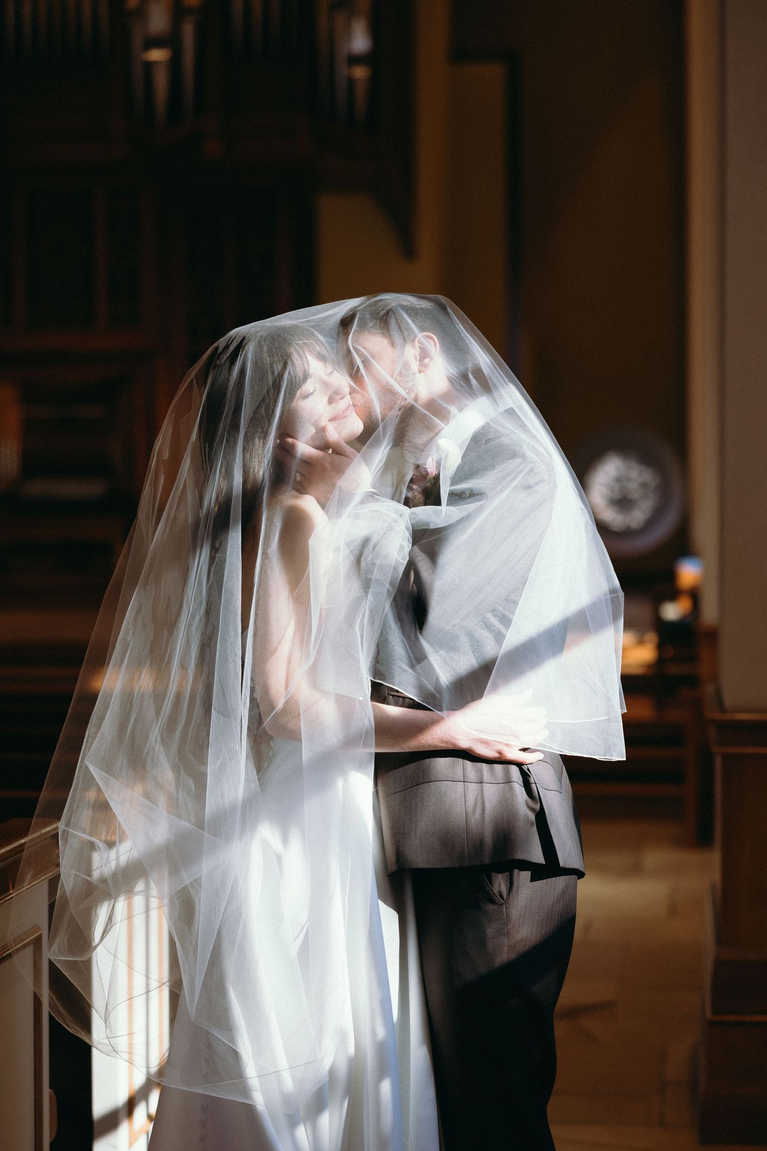 Romantic sequence of a couple in wedding attire dancing and dipping in an elegant indoor venue with dramatic lighting.