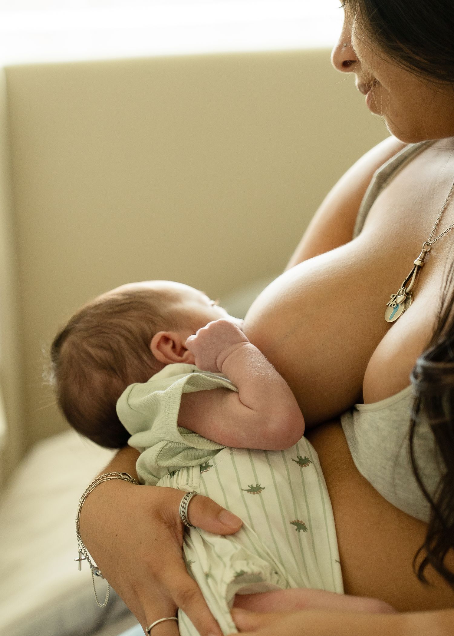 Lifestyle newborn session in Houston home featuring mom nursing her baby boy
