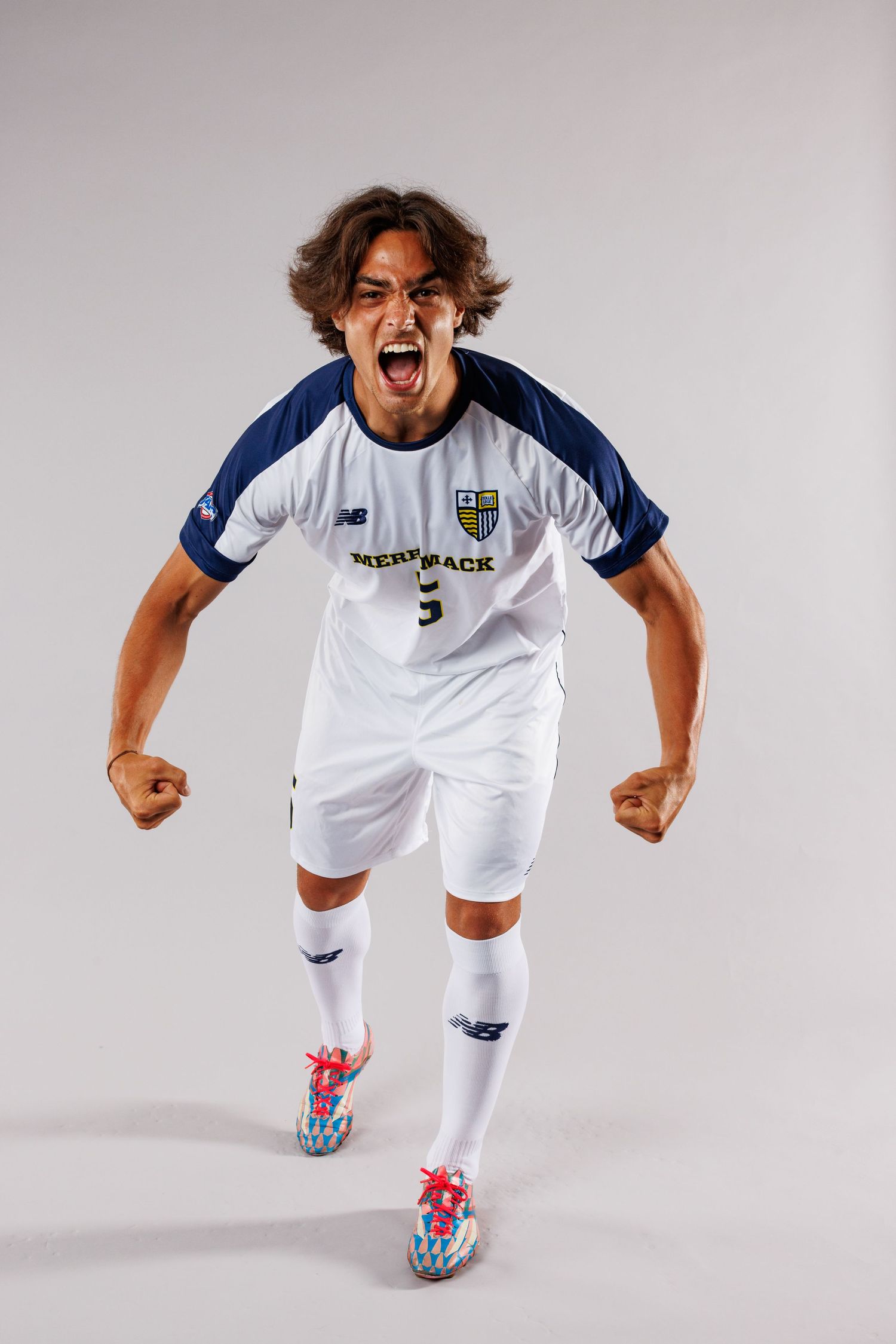 Soccer athlete in white uniform shows energetic poses and celebrations.
