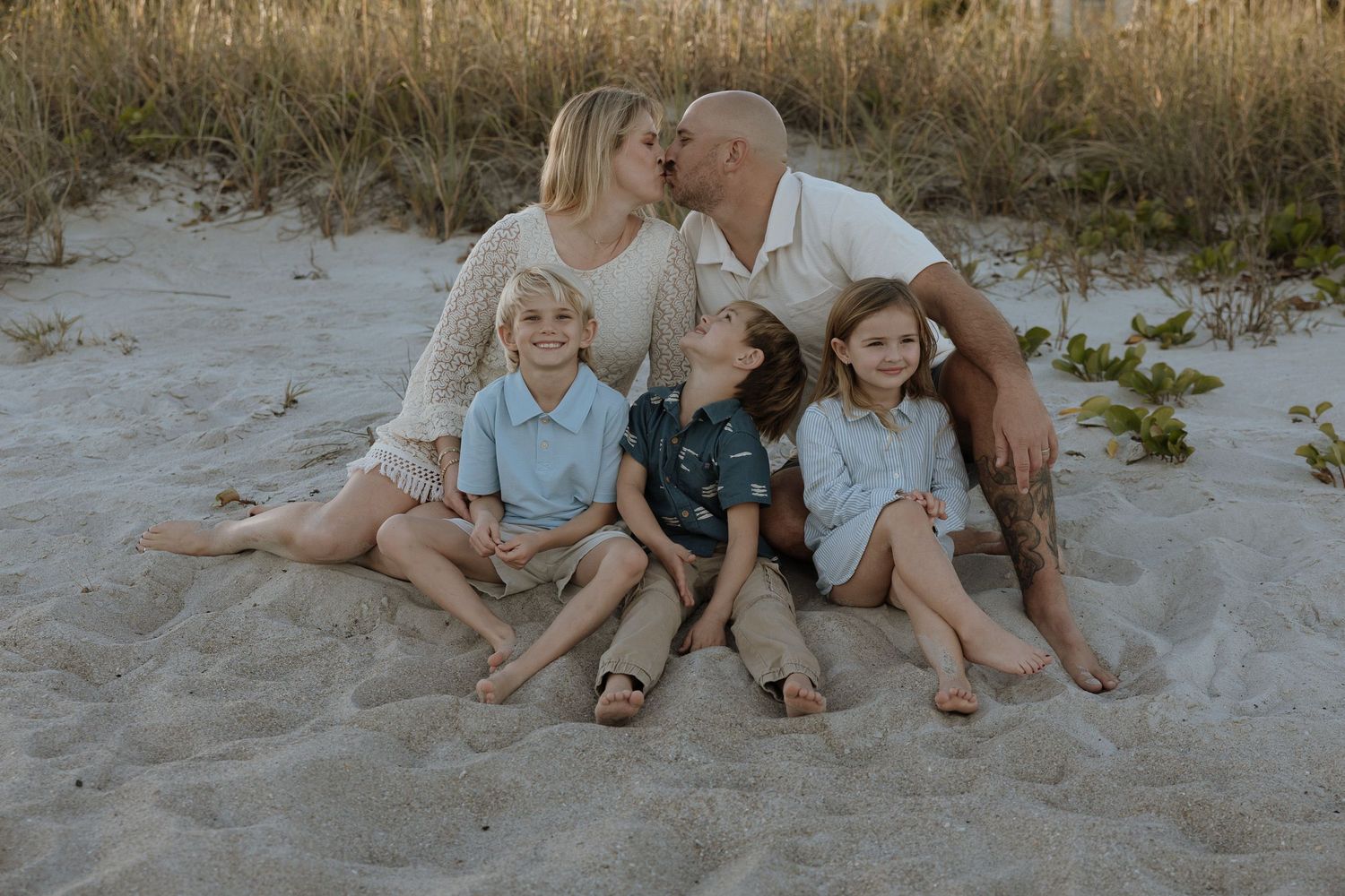 A series of black and white photographs showing tender moments between parents and their young children.