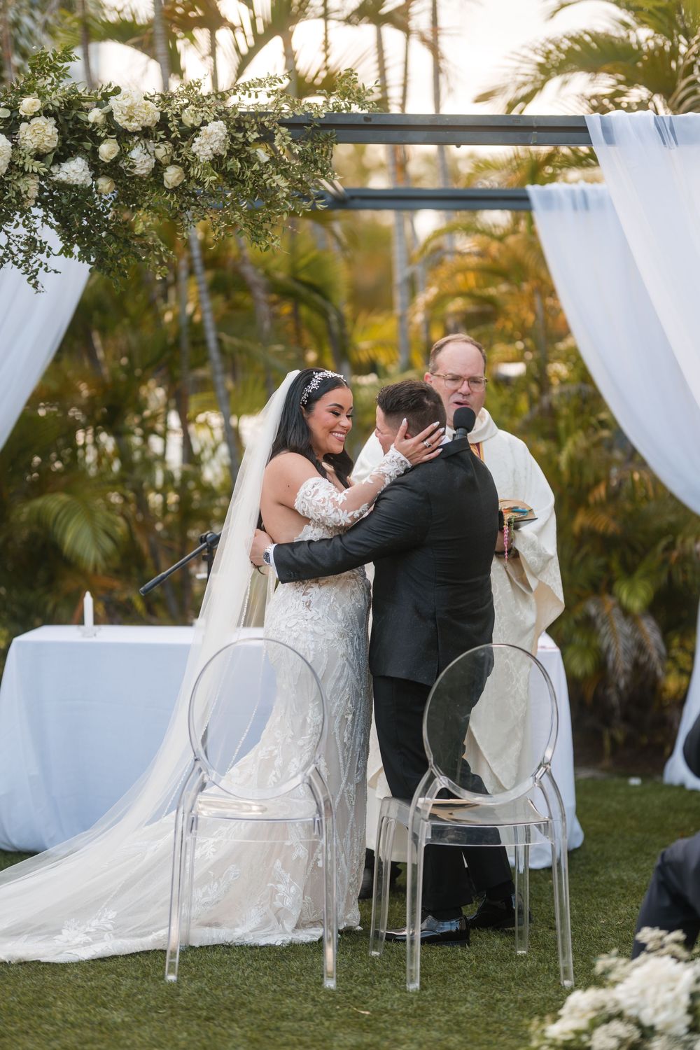 Bride and groom exchanging vows under arch during outdoor wedding ceremony in Puerto Rico