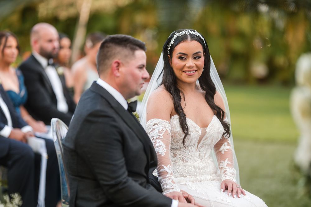 Bride and groom seated during ceremony listening to vows at Puerto Rico wedding