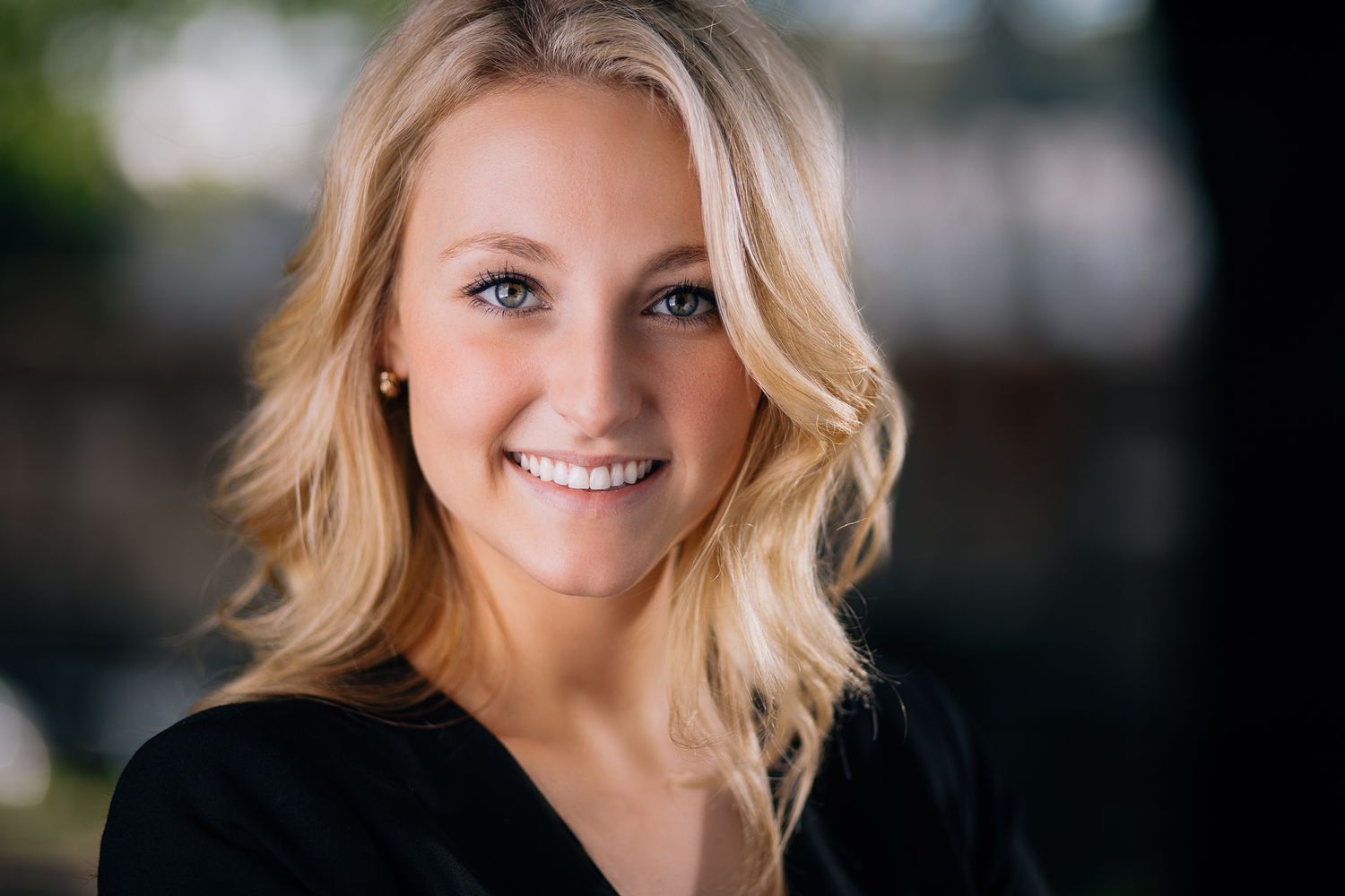 Professional headshot portraits of a woman with blonde hair against dark backgrounds.