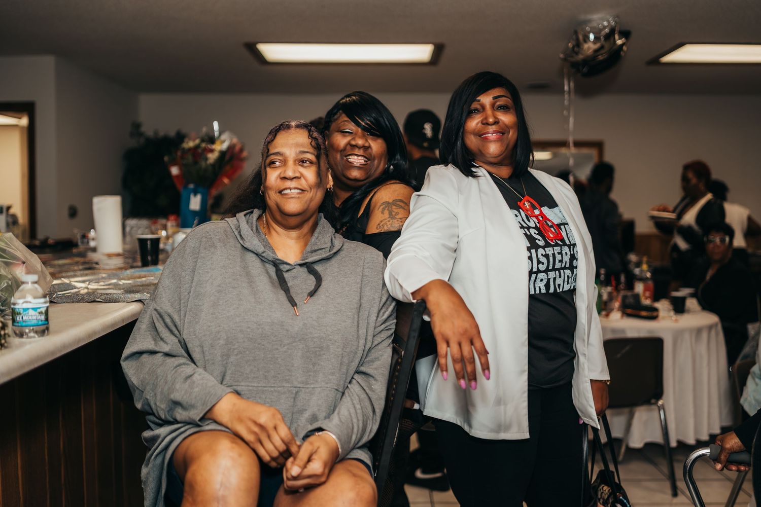 Indoor social gathering with multiple people in casual attire. event photography