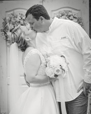 A romantic black and white wedding photo sequence showing tender moments between a couple during their special day.