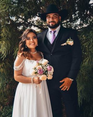 Outdoor wedding portraits featuring a couple in white dress and formal suit with floral bouquet.