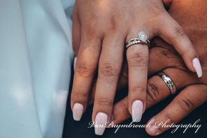 A series of close-up shots showing wedding rings and intertwined hands with white nail polish.
