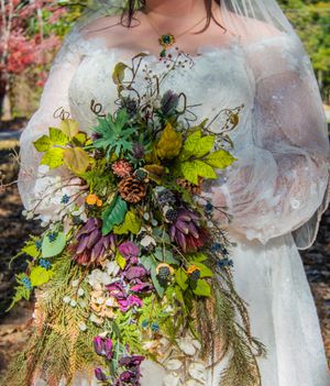 Close-up shots of a vibrant autumn wedding bouquet with purple flowers, green leaves and natural textures.