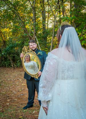 Wedding couple poses for romantic portraits in a scenic autumn forest with golden sunlight.