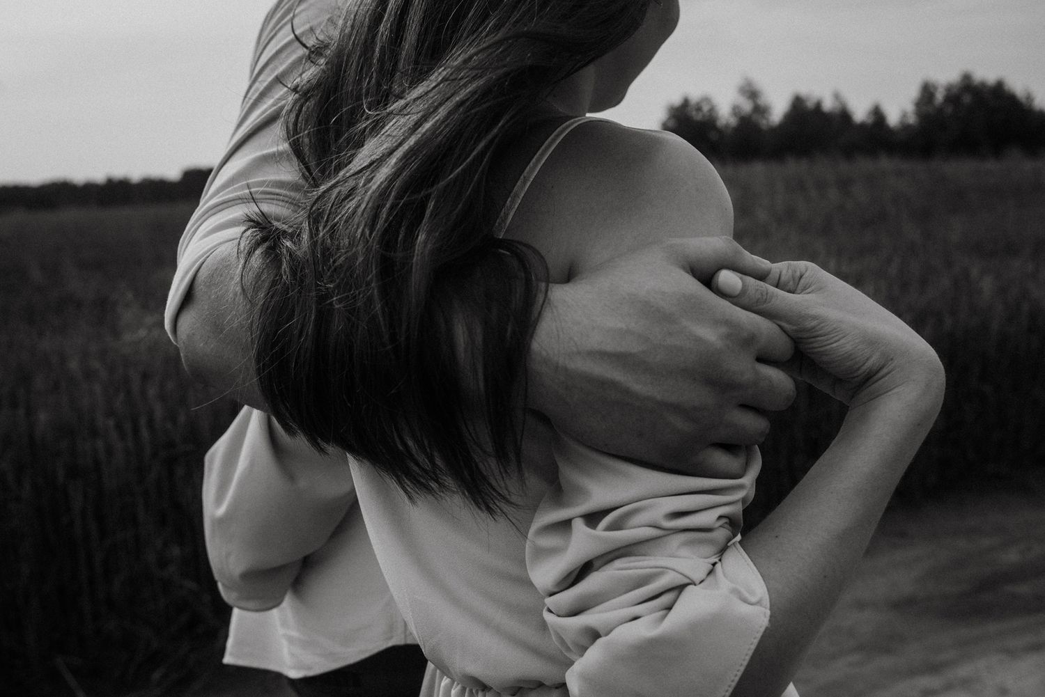 A black and white photo sequence shows two people dancing and embracing in a field at sunset.