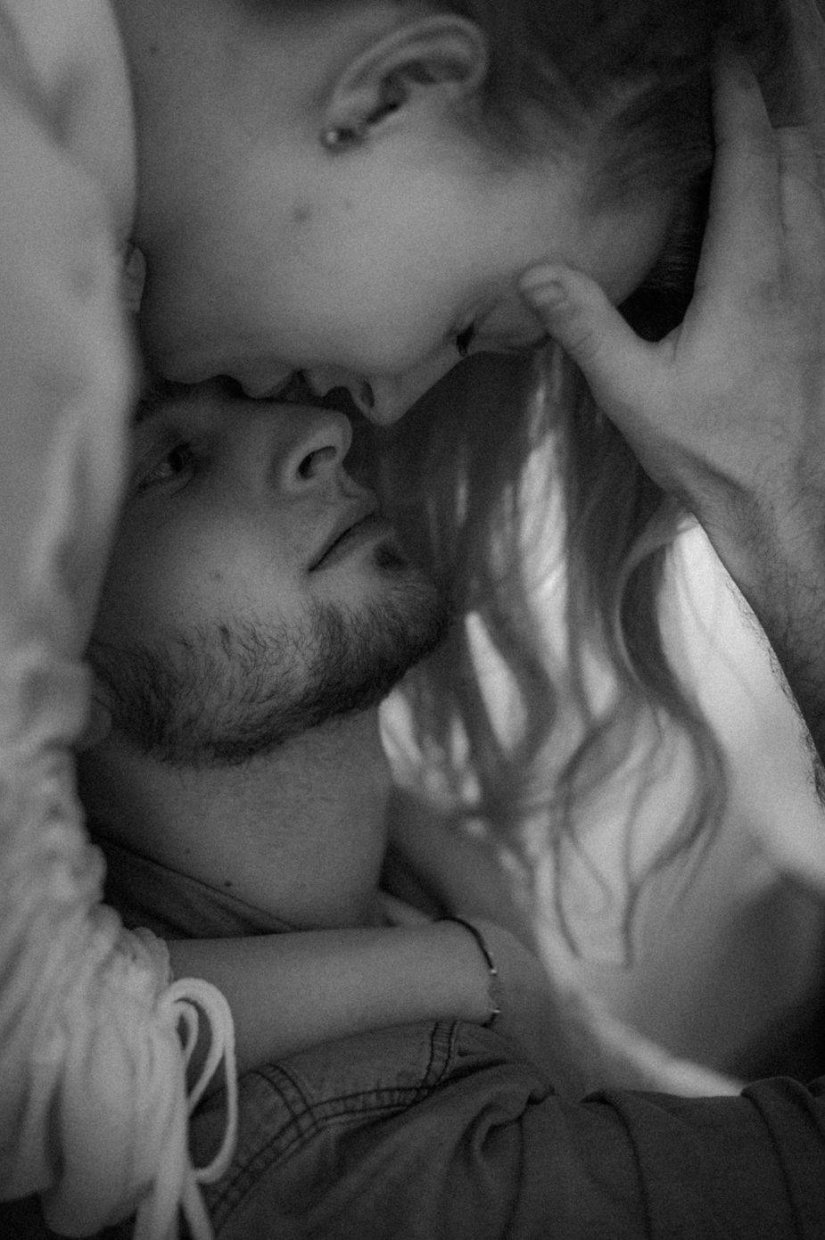 A romantic black and white photo series showing an intimate couple kissing in close-up shots.
