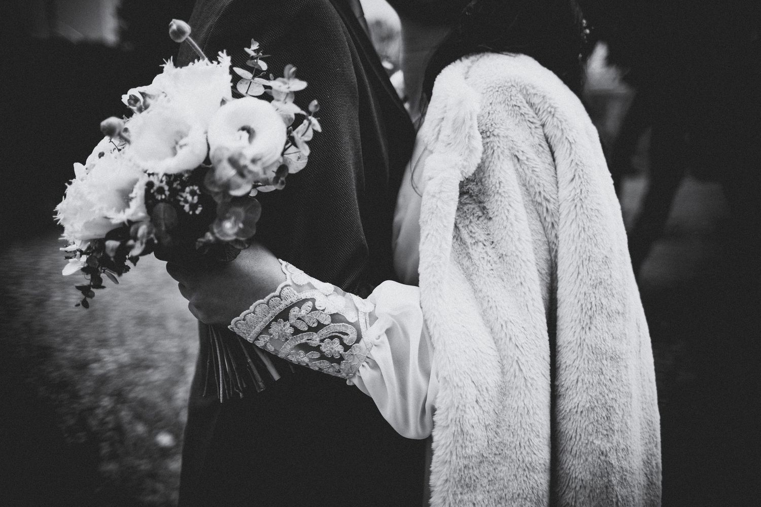 Black and white wedding photo series showing romantic moments between a couple in formal attire.