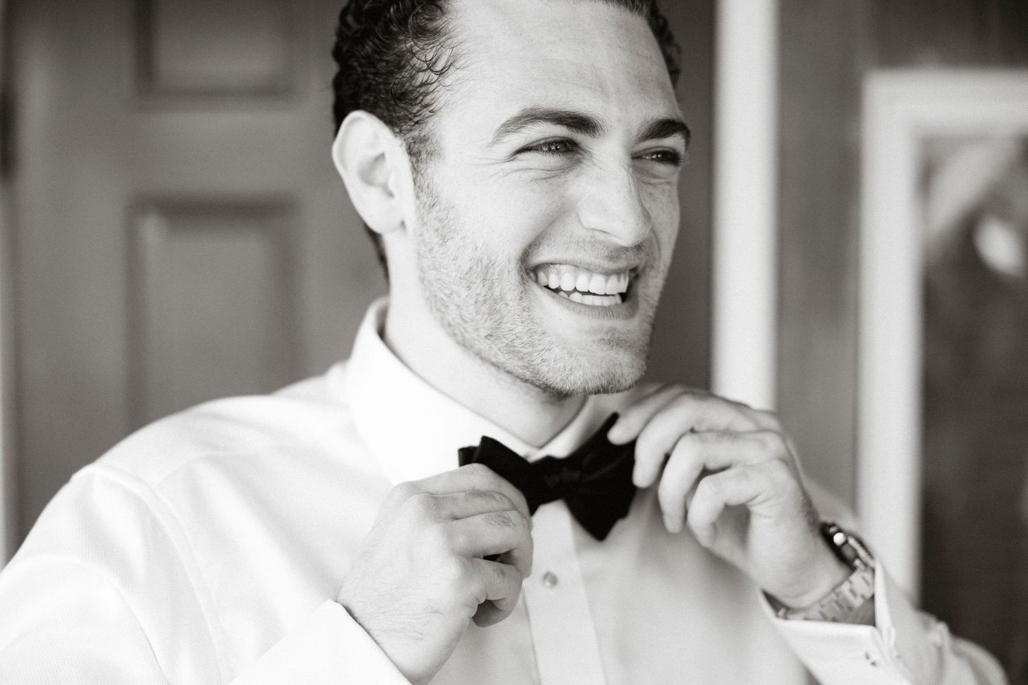 Black and white photo collage showing a person smiling in different candid poses.