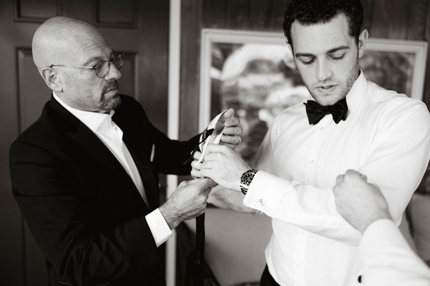 A tender moment captured in black and white as a couple shares an intimate dance at a wedding celebration.