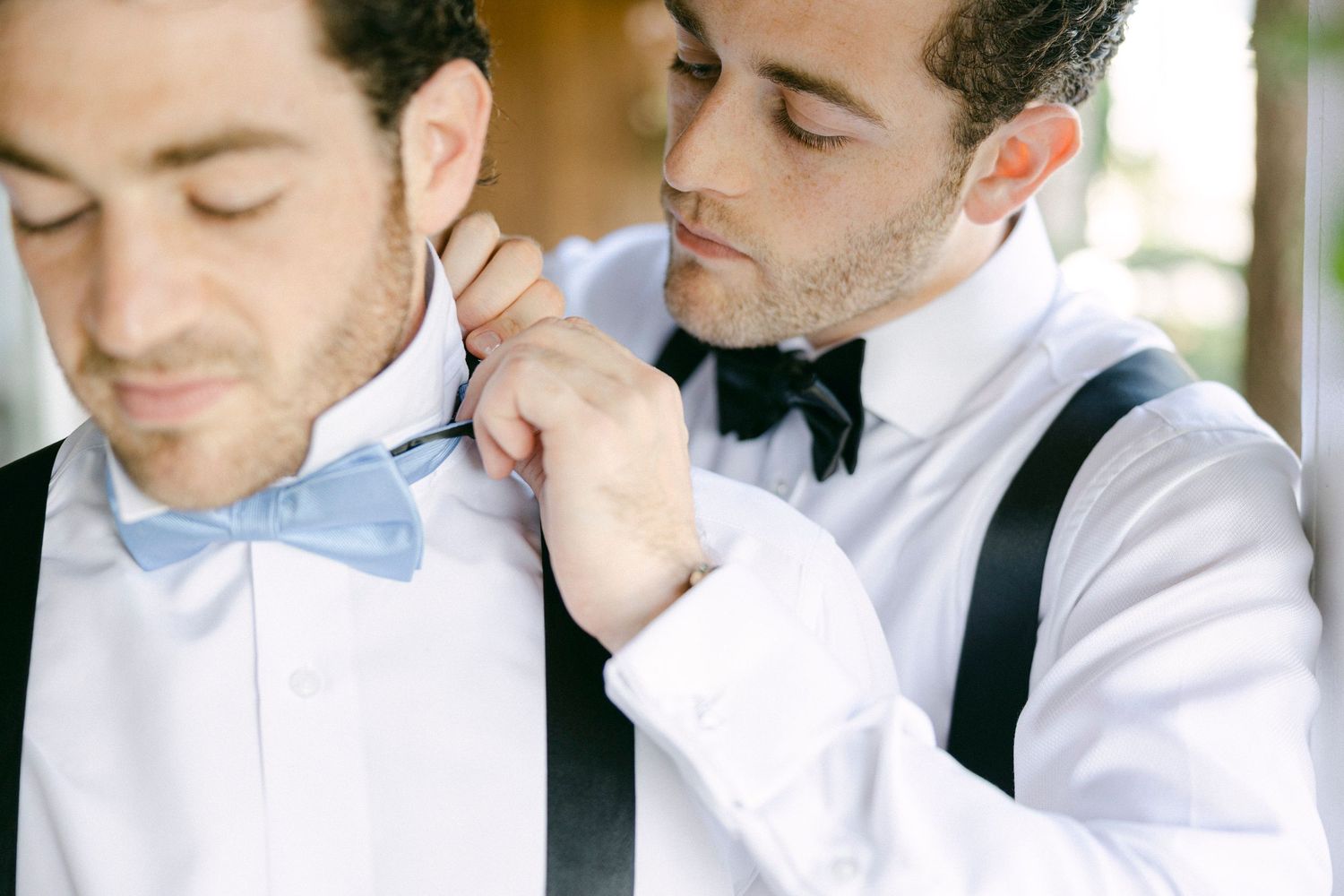 A group of groomsmen in matching white shirts and bow ties pose thoughtfully in a candid photo series.