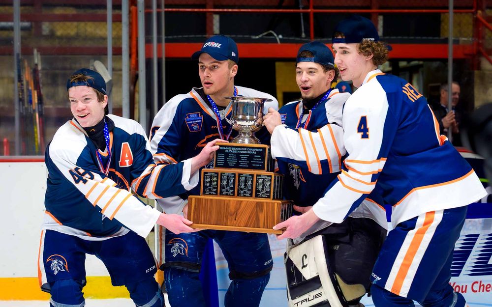 Trojans captains show off the championship trophy with smiles after the Bears Cup victory by SportsFox Photography, Hershey PA.