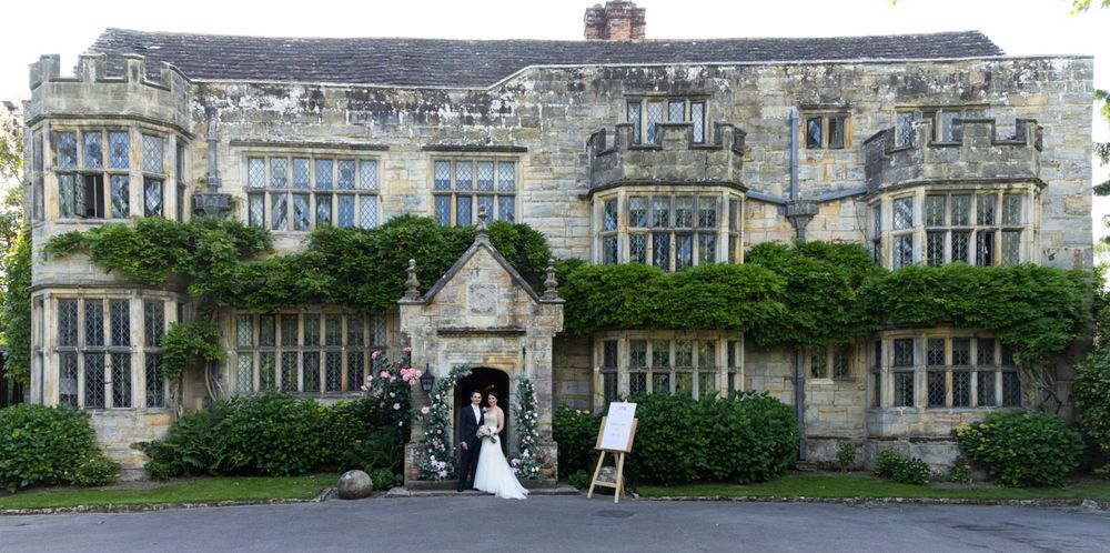Bride and groom in front of Smallfield Place