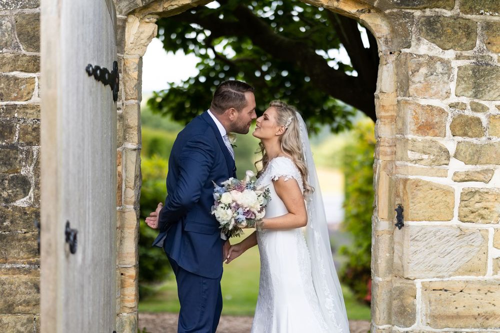 Bride and groom in gardens of Wadhurst Castle