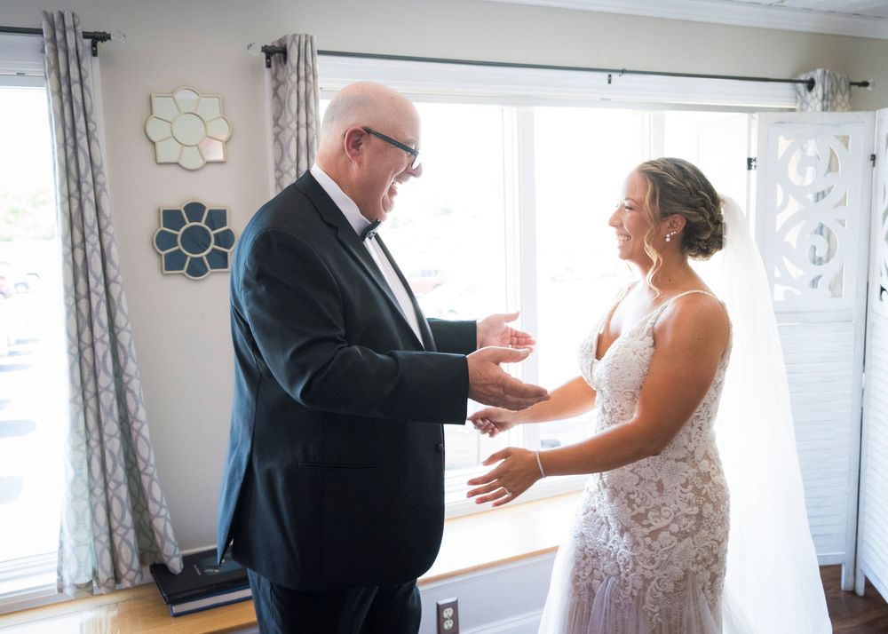 Father reacts emotionally seeing his daughter in her wedding dress before the ceremony.