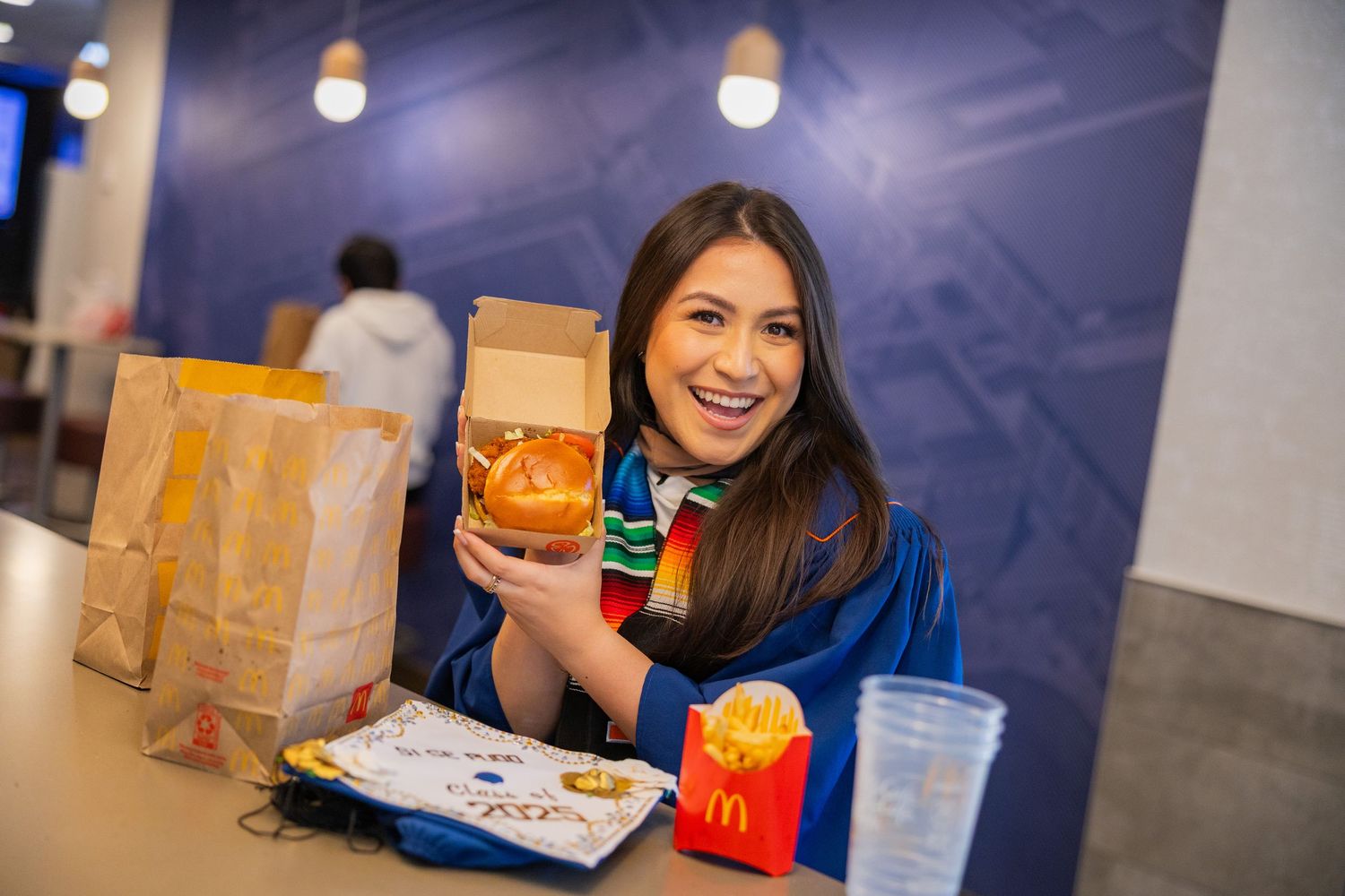 UIUC graduation photo at McDonald's with a burger and fries