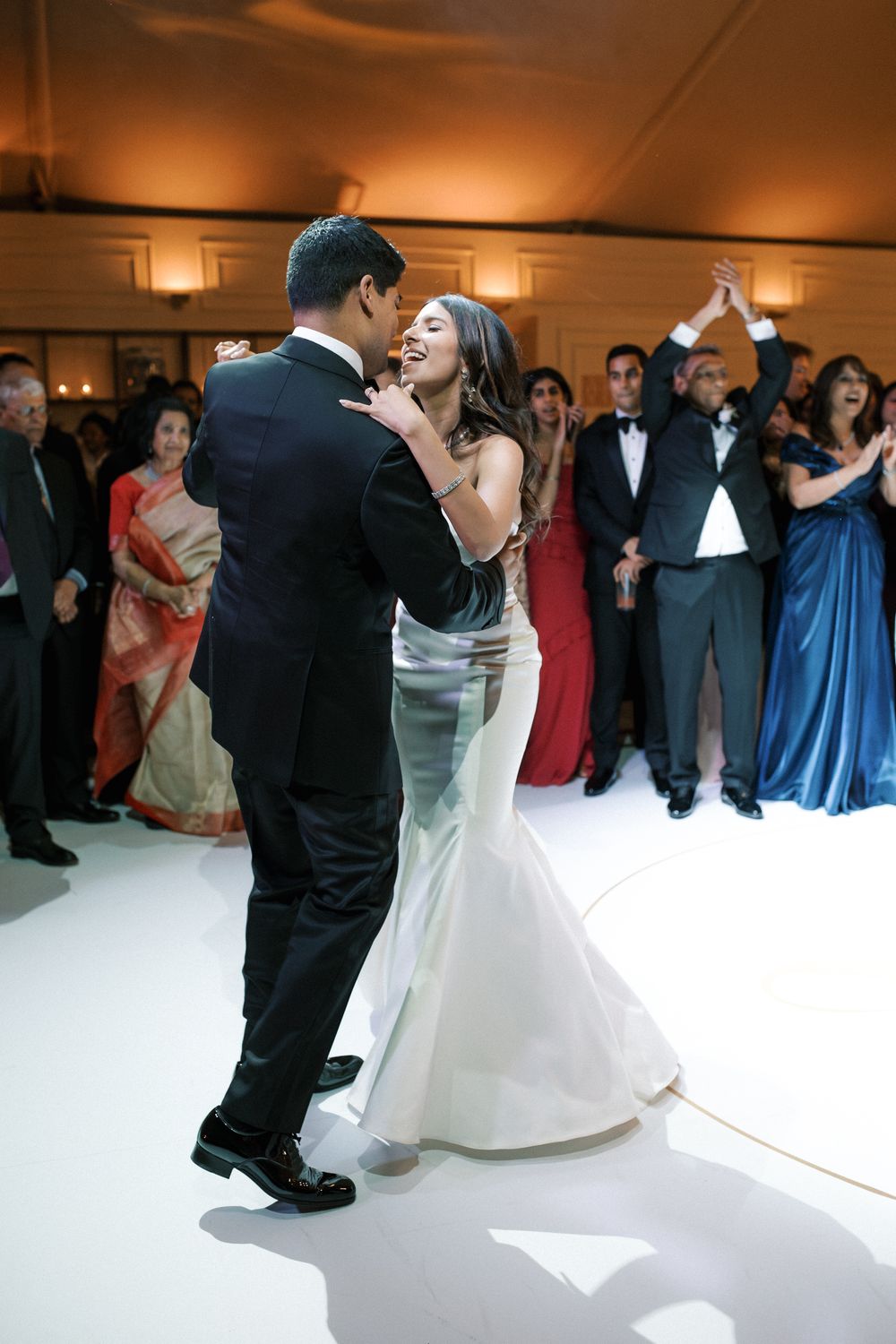 Bride and groom first dance surrounded by guests at luxury Indian wedding reception in Portugal at Corrio-Mor palace