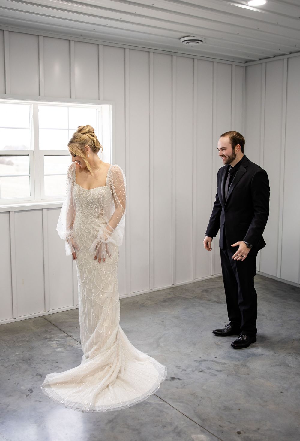 A series of wedding photos showing a couple in a minimalist white room with a romantic first look sequence.