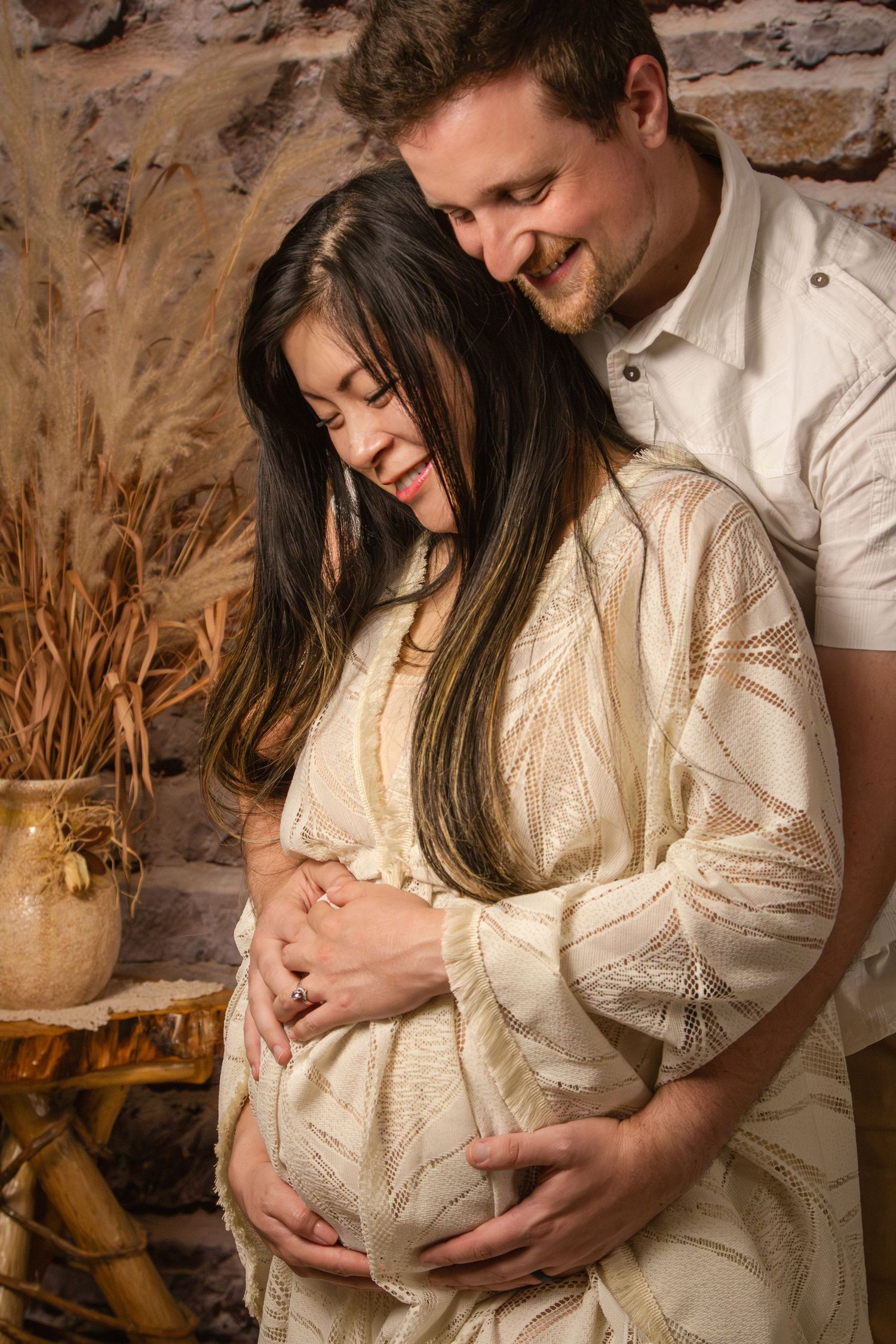 Boho maternity session parents holding belly handmade maternity gown