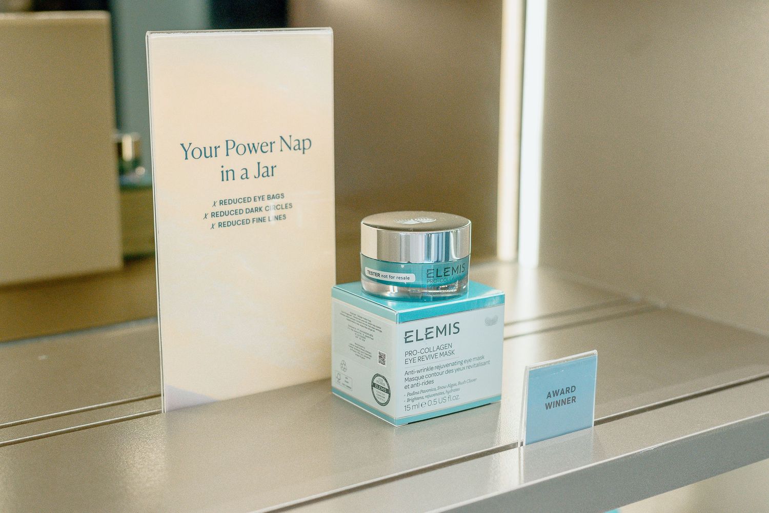 White pharmacy shelves displaying organized skincare and medical products in neat rows.