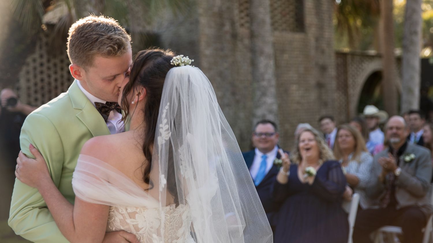Frederick Maryland Wedding Photographer  - Wedding couple shares intimate moment during outdoor ceremony as guests look on.