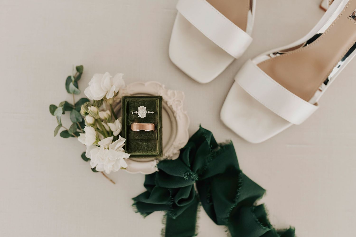 Elegant wedding invitation flat lay featuring sage green details and gold accents