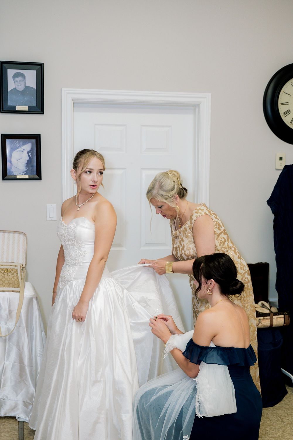 A sequence of photos showing a bride getting help putting on her white wedding dress in a home setting.