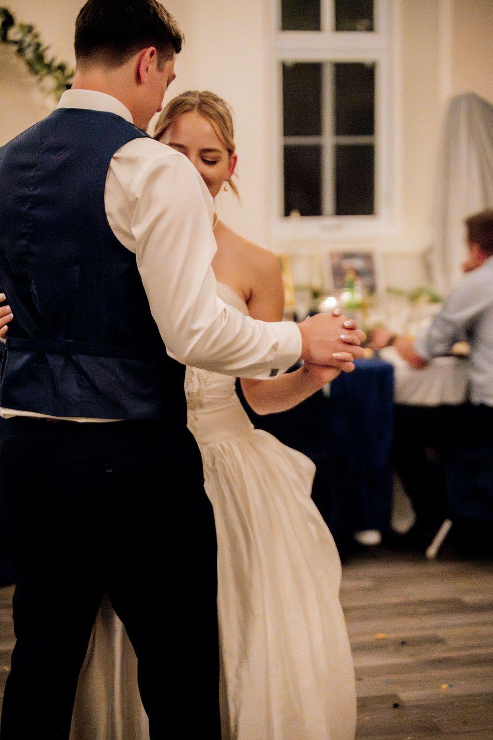 Couples dancing together at an elegant wedding reception in formal attire.