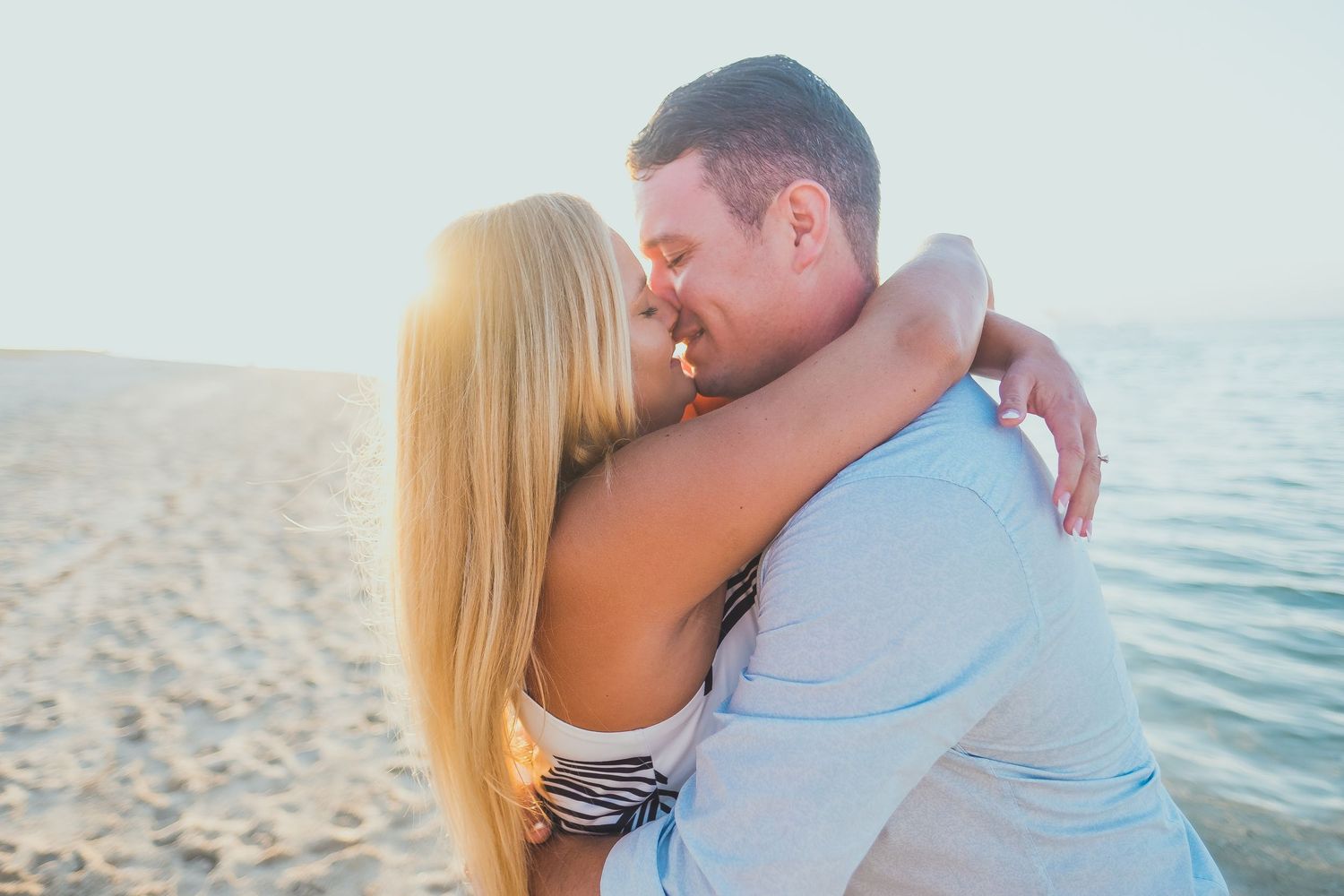 Romantic beach portraits with turquoise ocean in background.