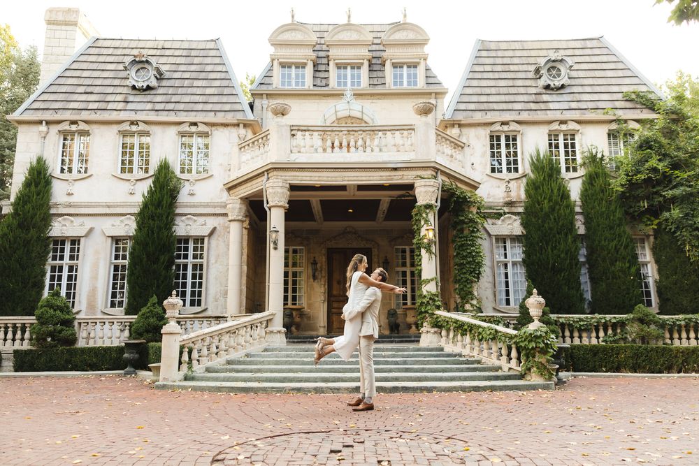 Elegant white mansion with grand staircase and classic French architecture features multiple exterior views.