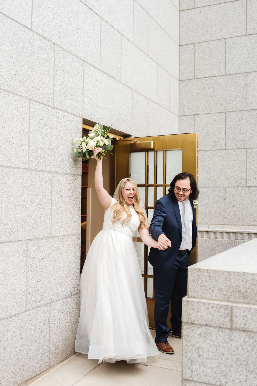 A bride and her escort walk through stone doorways in a series of joyful candid wedding moments.