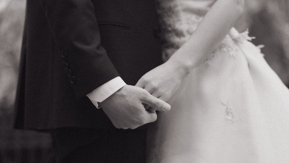 A romantic black and white wedding photo shows a couple sharing a tender moment. Couple Photoshoot Barcelona