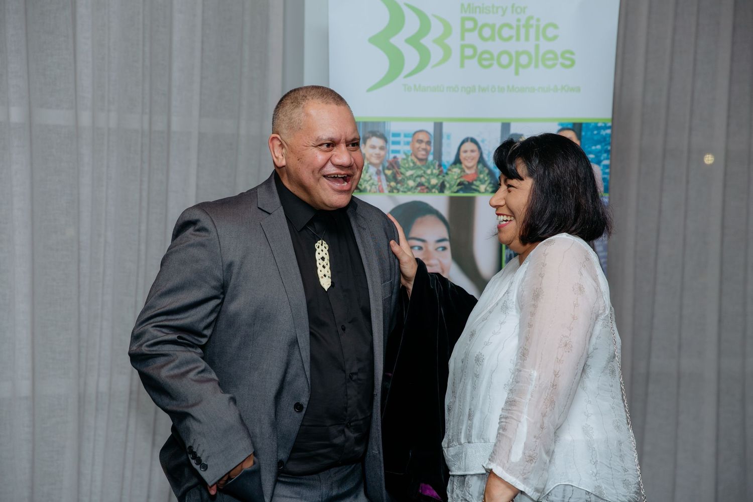 Two guests at an awards night event networking and enjoying themselves