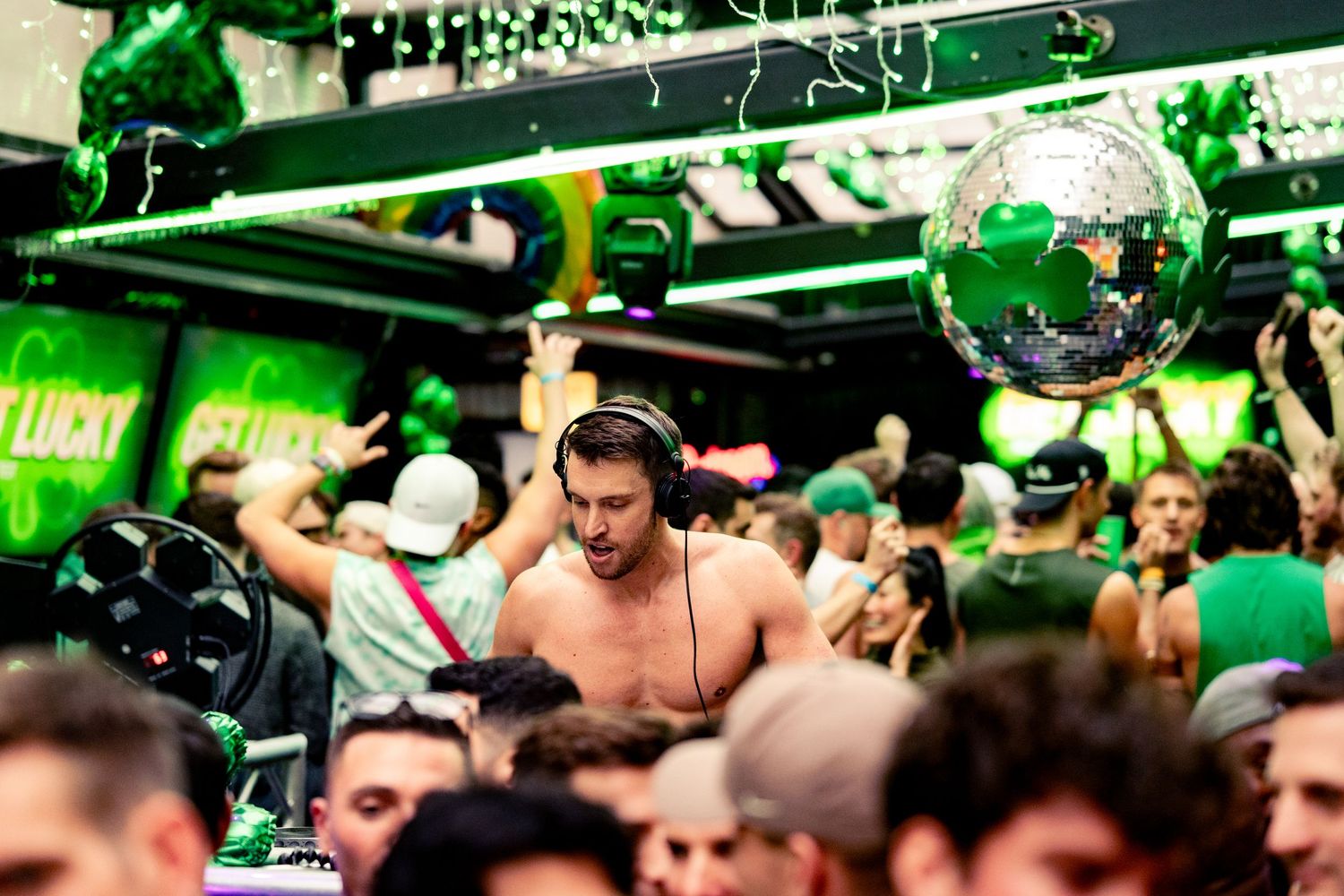 A DJ mixes for an event hosted by Dusty Carpenter at DS Tequila over St. Patricks Day weekend surrounded by partygoers