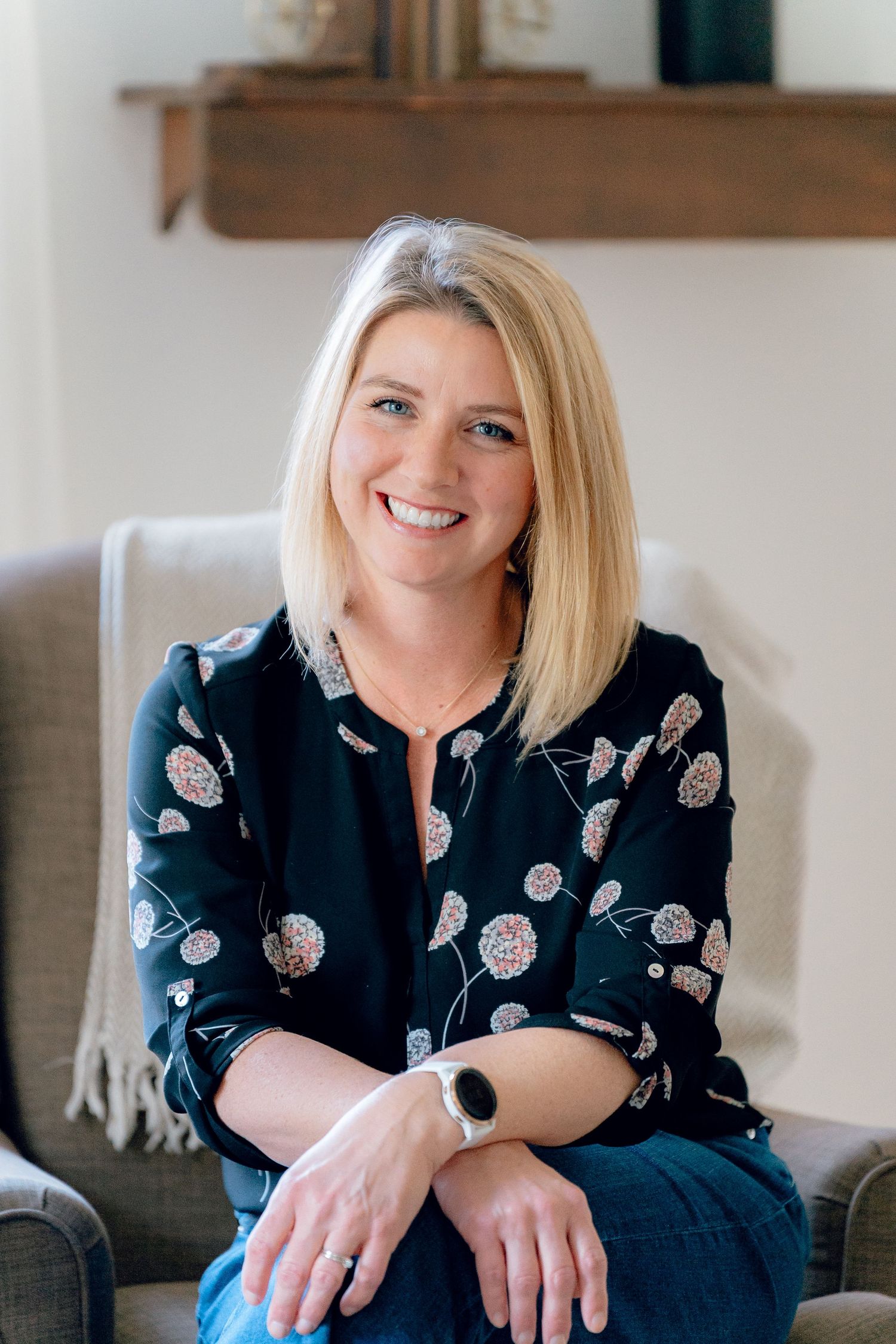 Professional portrait of Erin from Sister Home Systems in a black patterned blouse sitting casually for a brand photo session in Ohio.