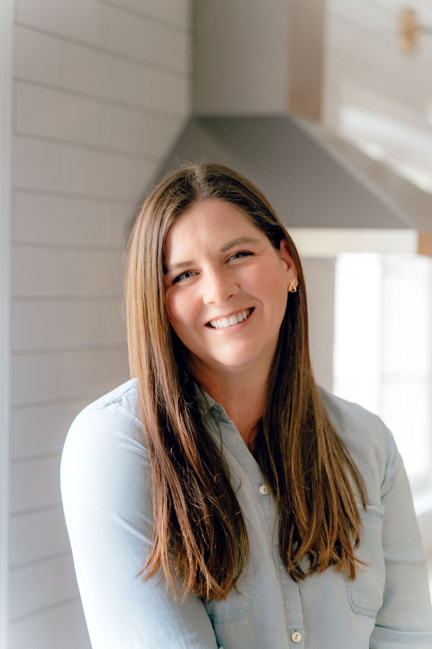 Professional headshot showing Emily from Sister Home Systems in white button-up shirt in Hudson, Ohio at a brand session.