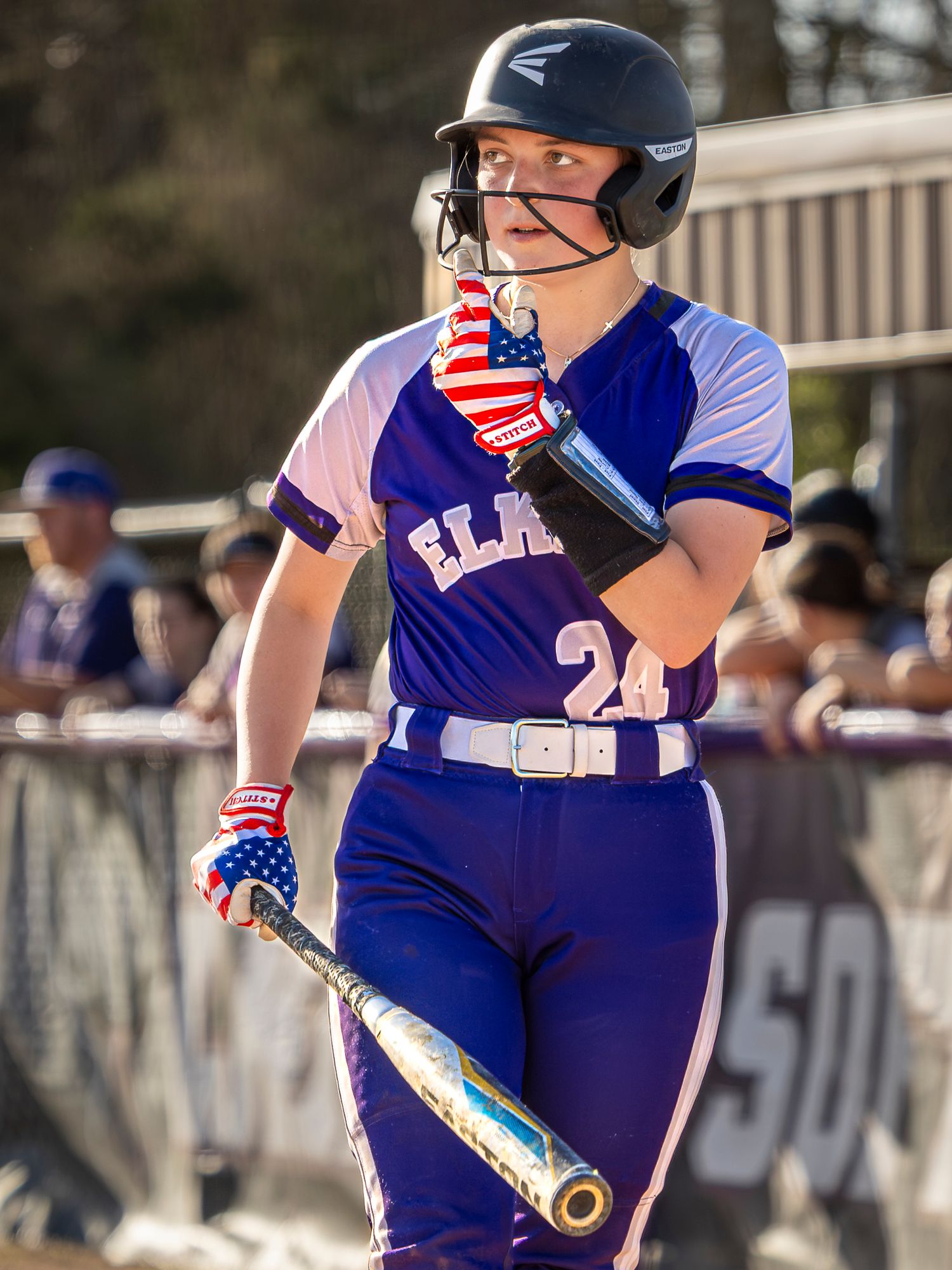 A sequence of five connected images showing a softball player's fielding stance and defensive movements on the infield dirt.